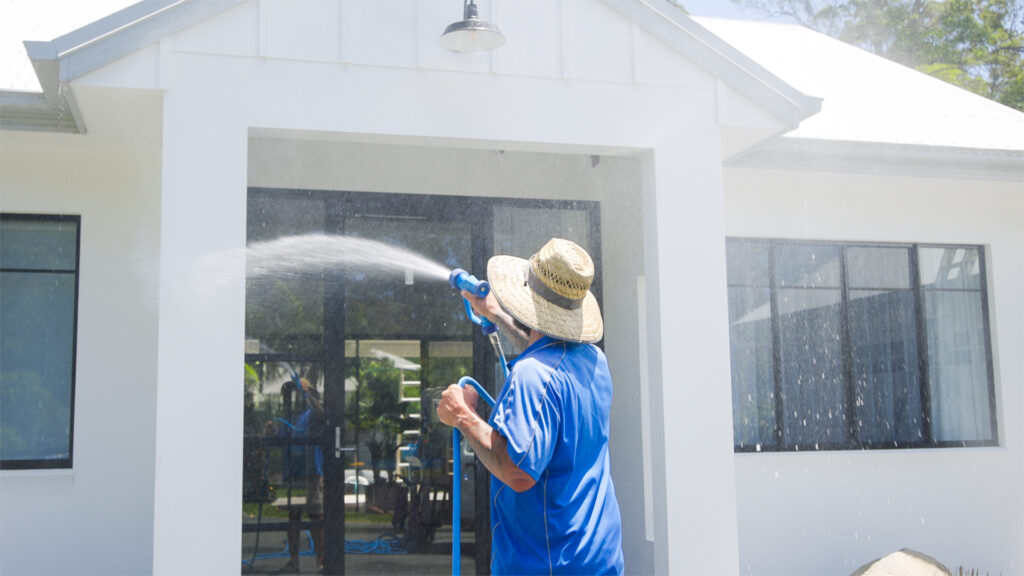 pressure cleaning window and walls of a home